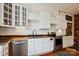 Bright kitchen features white cabinets, modern appliances, wooden countertops and hardwood flooring at 107 Hinton St, Chester, SC 29706