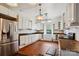 Bright kitchen features white cabinets, modern appliances, wooden countertops and hardwood flooring at 107 Hinton St, Chester, SC 29706