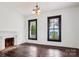 Bright living room featuring hardwood floors and vintage brick fireplace at 107 Hinton St, Chester, SC 29706