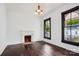 Bright living room featuring hardwood floors and vintage brick fireplace at 107 Hinton St, Chester, SC 29706