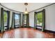 Bright living room featuring detailed trim, dark window frames, and hardwood floors at 107 Hinton St, Chester, SC 29706