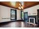 The living room features dark trim, hardwood floors, and a brick fireplace at 107 Hinton St, Chester, SC 29706