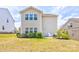 Back exterior view of the home with a patio, surrounded by a green yard at 1077 River Haven Sw Ave, Concord, NC 28025