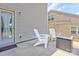 Back patio with two chairs and a table-style fire pit outside a door to the house at 1077 River Haven Sw Ave, Concord, NC 28025