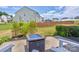 Landscaped backyard featuring a concrete patio with a fire pit and lush green lawn at 1077 River Haven Sw Ave, Concord, NC 28025