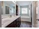 Well-lit bathroom featuring double vanity, soaking tub, and modern fixtures at 1077 River Haven Sw Ave, Concord, NC 28025