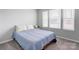 Bright bedroom with plenty of natural light, showcasing neutral walls and carpet at 1077 River Haven Sw Ave, Concord, NC 28025