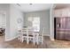 Charming dining area featuring wood floors, a modern chandelier, and stainless steel fridge at 1077 River Haven Sw Ave, Concord, NC 28025