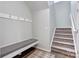 Functional entryway featuring a built-in bench, coat hooks, and staircase to the next level at 1077 River Haven Sw Ave, Concord, NC 28025