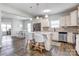 Modern kitchen with white cabinets, granite countertops, stainless appliances, and a center island at 1077 River Haven Sw Ave, Concord, NC 28025