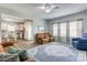 Inviting living room featuring plush seating, stylish rug, and plenty of natural light, seamlessly flowing to the kitchen at 1077 River Haven Sw Ave, Concord, NC 28025