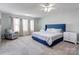 Spacious main bedroom with large windows, plush carpet, and a calming color palette at 1077 River Haven Sw Ave, Concord, NC 28025