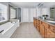 Bathroom featuring a large tub, shower, and double vanity, providing a luxurious feel at 10792 Elsfield Nw Ave, Concord, NC 28027