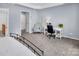 View of the bedroom featuring neutral paint, a comfortable sitting area and a desk at 10792 Elsfield Nw Ave, Concord, NC 28027