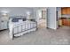 Relaxing bedroom with a wrought iron bed frame and an ensuite bathroom featuring a large soaking tub at 10792 Elsfield Nw Ave, Concord, NC 28027