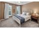 Inviting bedroom featuring natural light, white bedding, and soft textures, creating a cozy and serene atmosphere at 10792 Elsfield Nw Ave, Concord, NC 28027