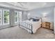 Inviting bedroom with large windows, allowing ample natural light and a stylish ceiling fan at 10792 Elsfield Nw Ave, Concord, NC 28027