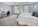 Bedroom showcasing a cozy work space with a large window offering natural light and an office chair and desk at 10792 Elsfield Nw Ave, Concord, NC 28027