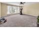 Spacious bonus room with large windows, ideal for a home gym or recreation area at 10792 Elsfield Nw Ave, Concord, NC 28027