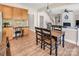 Cozy dining room featuring a wooden table with black chairs, complemented by wooden cabinets and granite countertops at 10792 Elsfield Nw Ave, Concord, NC 28027