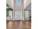 Welcoming foyer with soaring ceilings, detailed trim work, and wood flooring at 10792 Elsfield Nw Ave, Concord, NC 28027