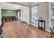 Inviting foyer with light wood floors and large windows, leading to dining area at 10792 Elsfield Nw Ave, Concord, NC 28027