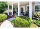 Inviting front porch featuring a porch swing, rocking chairs, and decorative plants enhancing the entrance appeal at 10792 Elsfield Nw Ave, Concord, NC 28027