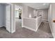 Bright hallway with neutral tones, leading to a spacious room with plenty of natural light and room for exercise equipment at 10792 Elsfield Nw Ave, Concord, NC 28027