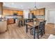 Well-lit kitchen featuring stainless steel appliances, wooden cabinets, and a dining area with a table and chairs at 10792 Elsfield Nw Ave, Concord, NC 28027