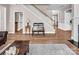 Open-concept living room with hardwood floors, a staircase, and comfortable seating, perfect for Gathering gatherings at 10792 Elsfield Nw Ave, Concord, NC 28027