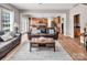 Open concept living room with hardwood floors and seamless flow to the kitchen at 10792 Elsfield Nw Ave, Concord, NC 28027