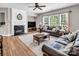 Comfortable living room with fireplace, plush sofas, and large windows at 10792 Elsfield Nw Ave, Concord, NC 28027