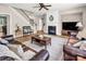 Bright living room with a fireplace, cozy seating, and staircase access at 10792 Elsfield Nw Ave, Concord, NC 28027