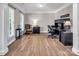 Cozy home office with natural light, desk, chair, and wood floors at 10792 Elsfield Nw Ave, Concord, NC 28027
