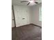 Spacious bedroom featuring neutral carpeting, a ceiling fan, and a double-door closet at 111 Billy Joe Rd, Mooresville, NC 28117