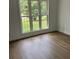 Bright bedroom with hardwood floors and large windows overlooking a green, lush outdoor space at 111 Billy Joe Rd, Mooresville, NC 28117