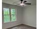 Well-lit bedroom featuring a ceiling fan and a window providing ample natural light at 111 Billy Joe Rd, Mooresville, NC 28117