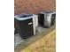 Two modern air conditioning units sit outside a brick home, ready to keep you cool at 111 Billy Joe Rd, Mooresville, NC 28117