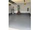 Two-car garage featuring steps to a door, epoxy flooring, and a water heater at 111 Billy Joe Rd, Mooresville, NC 28117