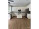 Bright kitchen featuring white cabinets, stainless steel appliances, granite countertops, and a kitchen island at 111 Billy Joe Rd, Mooresville, NC 28117