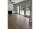 Bright living room features hardwood floors, a fireplace, and sliding glass doors to the backyard at 111 Billy Joe Rd, Mooresville, NC 28117