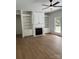 Bright living room features hardwood floors, a fireplace, and custom built-in shelving at 111 Billy Joe Rd, Mooresville, NC 28117