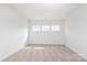 Bright, empty bedroom with three windows providing ample natural light at 1190 Sugar Creek Rd, Fort Mill, SC 29707