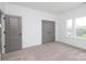 Bedroom featuring neutral walls and carpet, with closet doors and a window offering natural light at 1190 Sugar Creek Rd, Fort Mill, SC 29707