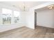 Bright dining room featuring hardwood floors, large windows, and modern chandelier at 1190 Sugar Creek Rd, Fort Mill, SC 29707