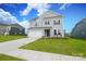 Charming two-story home with manicured front lawn and driveway leading to attached garage at 1190 Sugar Creek Rd, Fort Mill, SC 29707