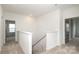 Upstairs hallway with oak stairs and white railing at 1190 Sugar Creek Rd, Fort Mill, SC 29707