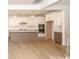 Bright kitchen with stainless appliances, island, and pendant lighting open to the living area at 1190 Sugar Creek Rd, Fort Mill, SC 29707