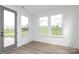 Bright sunroom with three windows and a view of the yard and a gray exterior door at 1190 Sugar Creek Rd, Fort Mill, SC 29707