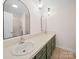 Bathroom features dual sinks, green cabinets, tile floors, and framed mirrors at 1261 Westbrook Cir, Gastonia, NC 28052